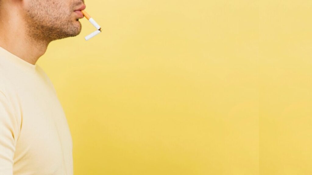 homem fumando um cigarro quebrado
